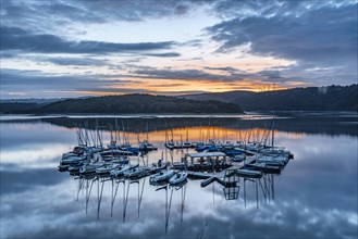 Blue hour over the Schwammenauel reservoir with sailing marina