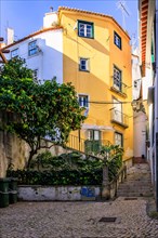 Old houses in narrow alleys and historic streets. Old house fronts in the morning and in the sunshine. the old town of alfama