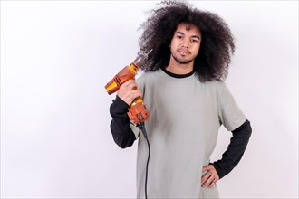 Portrait of the carpenter technician with the drill. Young man with afro hair on white background
