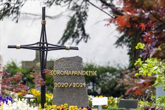 Grave with the word Corona Pandemie on the gravestone