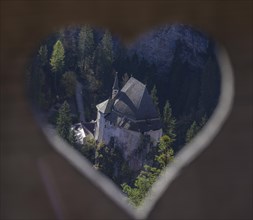 View through heart-shaped cut-out down to the former hermitage and place of pilgrimage