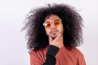Portrait in sunglasses with seductive look. Young man with afro hair on white background