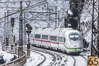InterCityExpress ICE of Deutsche Bahn drives through the snow
