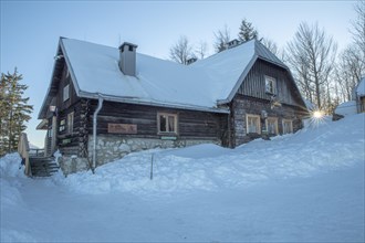 Snow-covered Anton Schosser Hut on the Hohe Dirn