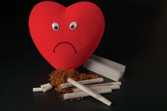 Sad heart with cigarettes and tobacco concept of unhealthy habits
