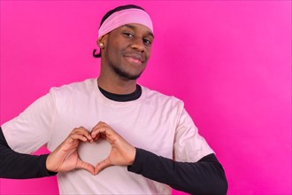 Black ethnic man in pink clothes on a pink background
