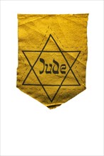 German Jewish badge showing yellow star saying Jude against white background