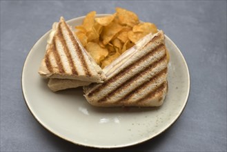 Ham and cheese toast served with chips
