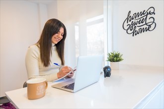 Businesswoman working with a computer smiling