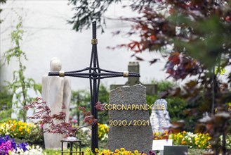 Grave with the word Corona Pandemie on the gravestone