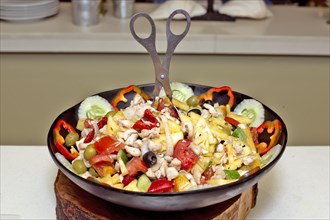 Mixed vegetable and fruit salad with chicken in a bowl