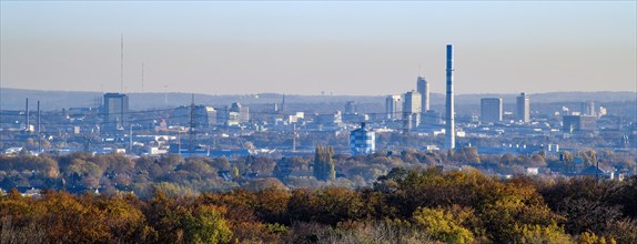 Panoramic view from slag heap in Ruhr area on skyline of Essen lies under haze due to air pollution