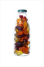 Glass bottle with fruit jelly on white
