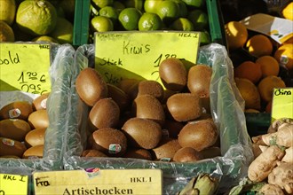 Kiwis and fruit with price tags at a market stall