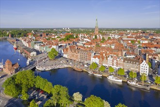 Aerial view over the river Trave and old sailing ships and boats in the old town of the Hanseatic City of Luebeck