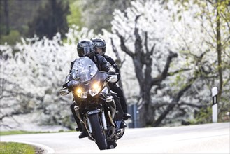 Spring ride on a motorbike over winding mountain passes