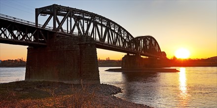 Haus-Knipp railway bridge over the Rhine with sunset