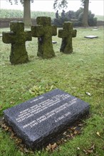 Stone crosses and gravestone of fallen German soldiers at the First World War One military cemetery Deutscher Soldatenfriedhof Langemark