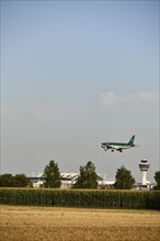 Air Lingus Airbus landing on Runway North with Tower Munich Airport and cornfield in foreground