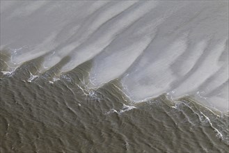 Aerial view of waves breaking on beach at the Schleswig-Holstein Wadden Sea National Park