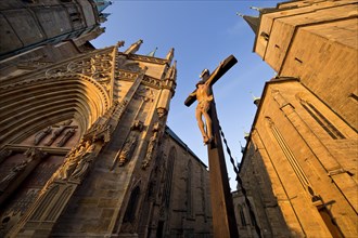 Jesus Christ on the cross between Erfurt Cathedral and Severi Church in early morning light