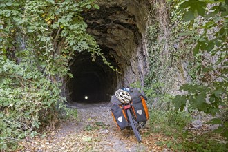 Trekking bike in front of old railway tunnel on the Ciro Trail