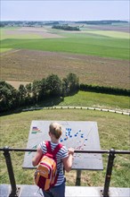 Tourist looking over the 1815 Waterloo battlefield from the Lions Mound at Braine lAlleud