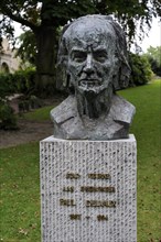 Bust of the surrealist painter Paul Delvaux in city park at Veurne