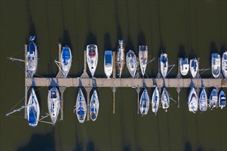 Aerial view over berthing jetty with sailing boats at marina in harbour of the city Stralsund along the Strelasund