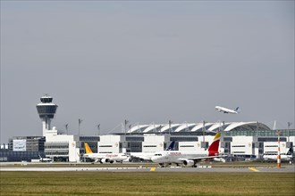 Iberia and Pegasus aircraft taxiing in front of Terminal 2