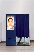 Passport photo machine with person