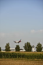 Eurowings Airbus A320 landing on Runway North with Tower Munich Airport and cornfield in the foreground