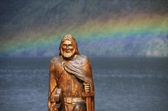 Wooden sculpture of Viking and rainbow over the Naeroyfjord