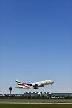 Take-off Emirates Airlines special livery 50th anniversary of the UAE United Arab Emirates Airbus A380-800 with tower in the background