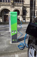Car park with electric charging station in front of the town hall