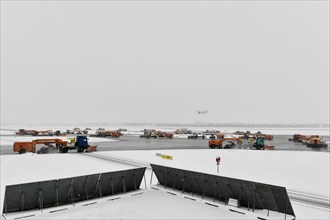 Sweepers clear snow on the taxiways and southern runway