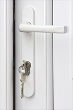 Keys unlocking a white door