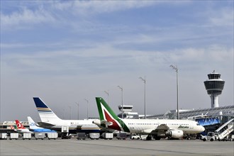 Aircraft on check-in position at Terminal 1 with tower
