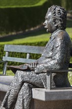 Albert Einstein statue sitting on a park bench at the seaside resort De Haan