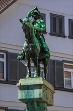 Bronze figure of the Postmichel on top of the Postmichel fountain in Fischbrunnenstrasse