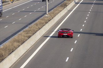 Ferrari drives in the overtaking lane when the motorway is clear