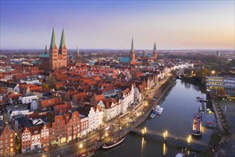 Aerial view over the river Trave and church towers in the old town of the Hanseatic City of Luebeck at sunset