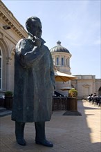 Bronze sculpture of King Baudouin and the Venetian Galleries at seaside resort Ostend along the North Sea coast