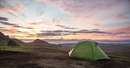 Tent overlooking rocky landscape Quiraing at sunrise