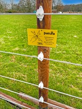 Warning sign on electric fence in wolf area Kirchhellen