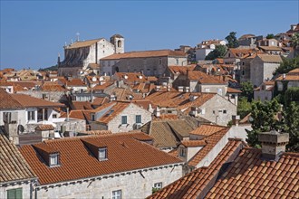 View over red roofs of houses and the Jesuit church of St. Ignatius in the Old Town