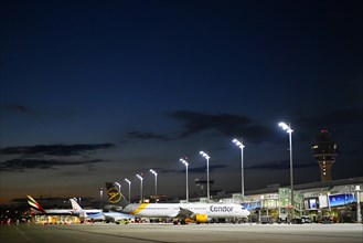 Terminal 1 at night with tower and Condor and TUI fly