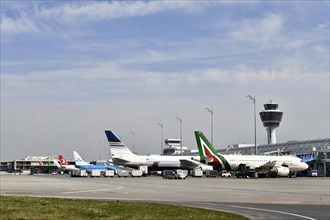 Aircraft on check-in position at Terminal 1 with tower