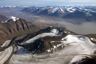 Aerial view of mountainous landscape with U-shaped glacial valley and retreating glaciers at Spitsbergen