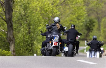Motorcyclist riding on a country road with many curves